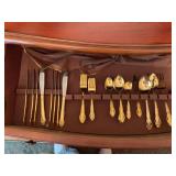 Gibson stainless gold flatware service for 8 with 5 serving pieces.  Missing 1 fork and 1 salad fork..