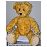 Research indicates this is a vintage mohair teddy bear, possibly from the 1920s to 1950s, featuring articulated joints. Has a 'handle' at the bottom of the back that swivels the teddy bear's head. Sim