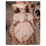 Elegantly dressed porcelain doll. 33 in tall.