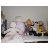 Shelf of dolls, clown, and mime.
