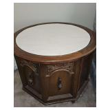 Octagon side table with round top and marble-look insert. Has one door for bottom storage. 26.5 in diameter x21-in tall.