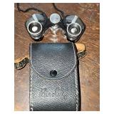 Binolux 7x18 theater binoculars, compact model typically used for opera or sporting events. Features fully coated optics and includes leather case.