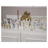 Shelf of decorative items including Angels, churches, porcelain gift box, and more.