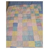 Hand crafted patchwork quilt in colors of yellow, pink, teal, white, and blue. Blue and white stripe on reverse. 76x90 in.