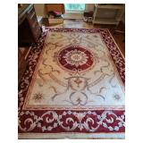 Beautiful 100% wool tufted area rug 7 ft 3 in x 9 ft 3 in. Includes underlay pad. Needs vacuumed. Pet friendly home.