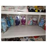 Grouping of nine TY beanie babies with hang tags and tush tags in protective cases.