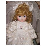 Grouping of porcelain dolls on stands.