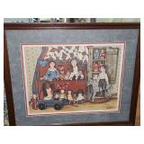 Limited edition 95/570 artist signed Sue Johnson 1986 of a framed folk-art print features an assortment of primitive dolls, a toy wagon, and a rocking horse arranged in a warm, rustic cupboard. 23x19 