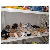 Shelf of beanie babies. Dogs, dragon, buffalo, anteater, and spider. Tush tags and hang tags are intact.