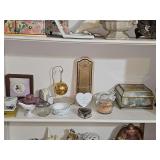 Shelf of decorative collectibles. Gold color ball is Lennox, Elephant powder box is Jeanette glass.
