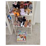 Two shelves of TY beanie babies with hang tags and tush tags and a grouping of magazines and beanie baby information.