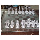 Three in one glass game set. Includes pieces for checkers, backgammon, and chess. One set is frosted, one set is clear. Comes in original box.