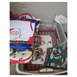 Container of Christmas aprons, tablecloths, placemats, pot holders, and more. See all photos