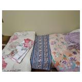 Full size purple print bed skirt and reversible comforter 74x86 in, blue reversible full size bedspread 83x100 in, and reversible King comforter with two pillow shams. 94x106. Needs laundered.