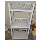 White three shelf wicker stand. 14 x 9 x 31.5 in tall.