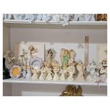 Home decor shelf of primarily Angels. Includes two 3D cherub wall hangings, a green glass bell and a crystal bell, and more.