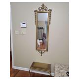 Mid century ornate scroll work Rococo or Baroque style gilt mirror with two leg bench. Mirror is 18x59 in tall. Bench is 22.5x 11.25x 13.75 in tall.