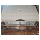 Vintage Aiwa TP-32A portable reel-to-reel tape recorder from the 1960's, featuring controls for volume, record, and play. It operates using a combination of a 1.5V battery for the motor and a 9V batte