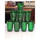 Set of 8 vintage Anchor Hocking forest green juice glasses in the pressed 'Sandwich' pattern, featuring an embossed floral and stippled texture design produced during the mid-20th century.