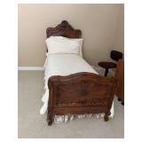 Antique French, twin size bed with linens.