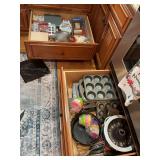 Contents of two drawers in  kitchen cabinet of bakeware and decorating and supplies