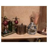 Decor pieces on shelf.  Brass tin, crystal candleholder, Bradford exchange Shih Tzu