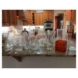 Large group of vases above microwave