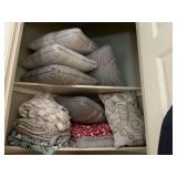 Assortment of throw pillows and blankets as shown
