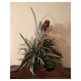 Faux greenery mounted on a flat tile as shown above secretary