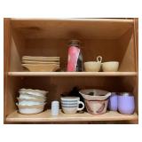 Two shelves of miscellaneous kitchen wires has shown