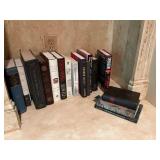 Assortment of books on bottom shelf in living room and u deer cabinet