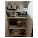 Contents of cabinet in attic. Appears to be baking items and storage items.