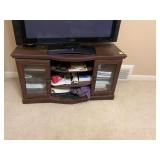 Television stand with double glass doors and three media shelves. 47 1/2“ x 20 1/2“ x 25“.