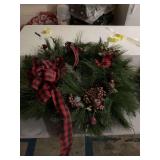 33 inch Christmas week with a candle holder that spans about 18 inches and a bow