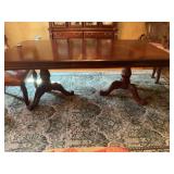 Seven piece elegant expandable, intricately detailed ￼Cherry dining set with six chairs. Double pedestal table with one 14 inch leaf. 43 1/2” x 66” x 30”.  The chairs measure 27“ x 25“ x 4