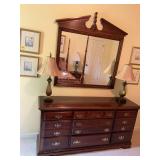 Cherry triple dresser with nine drawers and mirror. The dresser is 64“ x 18“ x 31 1/2“ the mirror measures 44“ x 47“.