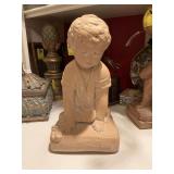 11“ x 6 1/2“ statue of a boy kneeling. Painted concrete.