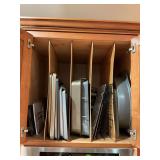 Cabinets above stove of bakewear. See photos.