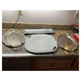 Four starving platters; Arthur Court 19” x 6” elephant tray, 15 1/2 in.² Wilton metal tray and two gold and silver metal Trays