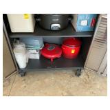 Contents of bottom shelf of storage cabinet in garage