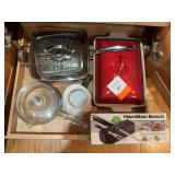 Contents of bottom, pullout drawer. Contains an electric knife, corning ware pot, copper pan with fry basket-looks to be new and a new red La Creuset casserole dish and a vintage Pyrex pot with lid.
