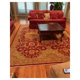 Oriental wool rug in Red, gold and sage green. 9’ x 11 1/2’.