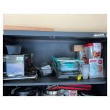 Assortment of kitchen items on top shelf in garage cabinet