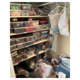 Yarn and supplies on left side of closet; four shelves and floor area