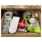 Contents of Top two drawers in kitchen by stove