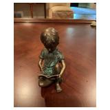 Bronze statue of a little boy writing. 6” x 4” by SPI.
