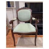 Traditional walnut carved wood accent mahogany armchair with padded armrests, and a light green textured dot-pattern upholstered oval back and seat - 23 x 18-1/2 x 17-1/2 tall to seat (36 tall overall