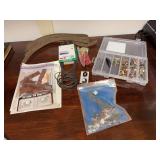 Clear storage container with lots of miscellaneous train accessories