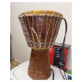 Vintage West African hand-carved wooden djembe drum featuring a rope-tuned animal skin head and decorative carvings along its base - 10”D x 16” tall