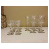 Set of (16) crystal wine glasses with etched floral & leaf motif - (8) are 5-1/4 tall and (8) are 7-3/4 tall and- comes with quilted storage box